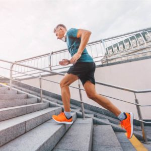 Healthy guy running up stairs
